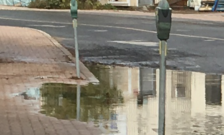 water over sidewalk and road